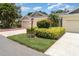 Inviting villa featuring a well-manicured lawn and vibrant flowerbeds at 2403 Nantucket Field Way # 27, Sun City Center, FL 33573