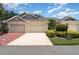 Charming villa with two car garage, mature landscaping, and inviting curb appeal at 2403 Nantucket Field Way # 27, Sun City Center, FL 33573