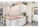 Bright kitchen with a sink, white cabinets, wooden countertops, and stainless steel dishwasher at 2403 Nantucket Field Way # 27, Sun City Center, FL 33573