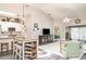 Open-concept living area with vaulted ceilings, modern furnishings, and seamless flow to the kitchen and outdoor spaces at 2403 Nantucket Field Way # 27, Sun City Center, FL 33573