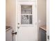 Mud room door with a window with a view to the house interior and white walls at 2403 Nantucket Field Way # 27, Sun City Center, FL 33573