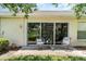 Cozy patio with outdoor seating and a view of the landscaped yard at 2403 Nantucket Field Way # 27, Sun City Center, FL 33573