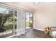 Cozy sunroom area with sliding glass doors and views of the backyard at 2403 Nantucket Field Way # 27, Sun City Center, FL 33573
