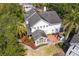 Aerial view of the property showcasing manicured lawn, patio, and lush greenery at 2403 W Sunset Dr, Tampa, FL 33629