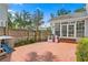 Spacious backyard with brick patio, playhouse, and fenced perimeter, perfect for Gathering activities at 2403 W Sunset Dr, Tampa, FL 33629