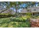 A spacious backyard includes a playground, lush greenery, and mature landscaping at 2403 W Sunset Dr, Tampa, FL 33629