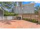 Brick-paved backyard features a storage shed, play structure, and fenced perimeter for added privacy at 2403 W Sunset Dr, Tampa, FL 33629