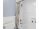 Bathroom featuring shower, white tiled walls, and a niche for toiletries at 2403 W Sunset Dr, Tampa, FL 33629