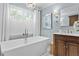 Light filled bathroom featuring a freestanding tub and a single sink vanity at 2403 W Sunset Dr, Tampa, FL 33629