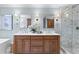 Bathroom featuring a double sink vanity, marble countertops and a glass-enclosed shower at 2403 W Sunset Dr, Tampa, FL 33629