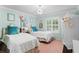 Stylized bedroom with two beds, a chandelier, natural light, and whimsical decor at 2403 W Sunset Dr, Tampa, FL 33629