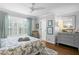 Sunlit bedroom with ceiling fan, shutters, and stylish furnishings at 2403 W Sunset Dr, Tampa, FL 33629