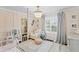Light and airy bedroom featuring a crib, armchair, natural light and walk-in closet at 2403 W Sunset Dr, Tampa, FL 33629