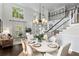 Elegant dining area with natural light, a large staircase, and seating for six at 2403 W Sunset Dr, Tampa, FL 33629