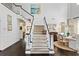 Grand entryway with a staircase, hardwood floors, and a dining area with elegant decor at 2403 W Sunset Dr, Tampa, FL 33629