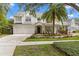 Beautiful two-story home with a well-manicured lawn, a two-car garage, and a welcoming front porch at 2403 W Sunset Dr, Tampa, FL 33629