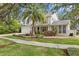 Charming two-story home with a manicured lawn, mature trees, and a well-maintained exterior at 2403 W Sunset Dr, Tampa, FL 33629