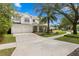 Attractive two-story home with a spacious driveway, manicured lawn, and a classic architectural design at 2403 W Sunset Dr, Tampa, FL 33629