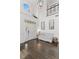 Elegant foyer with hardwood floors, a high ceiling, and a charming bench seating area at 2403 W Sunset Dr, Tampa, FL 33629