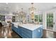 Open concept kitchen featuring an island with seating and views to the dining and living areas at 2403 W Sunset Dr, Tampa, FL 33629