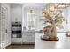Bright kitchen with white cabinets, subway tile backsplash, and stainless steel appliances at 2403 W Sunset Dr, Tampa, FL 33629