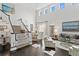 Bright and open living room with hardwood floors, high ceilings, and a staircase at 2403 W Sunset Dr, Tampa, FL 33629