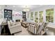 Cozy living room featuring a fireplace, built-in shelving, and French doors at 2403 W Sunset Dr, Tampa, FL 33629