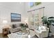 Bright living room featuring hardwood floors, high ceilings, and large windows at 2403 W Sunset Dr, Tampa, FL 33629
