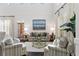 Bright living room with high ceilings, plantation shutters, and comfortable seating arrangements at 2403 W Sunset Dr, Tampa, FL 33629