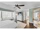 Spacious main bedroom with a window seat, a ceiling fan, and an ensuite bathroom at 2403 W Sunset Dr, Tampa, FL 33629