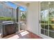 Outdoor patio with screened entry, brick flooring, and a grill ready for outdoor entertaining at 2403 W Sunset Dr, Tampa, FL 33629