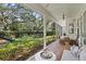 Screened-in patio with brick flooring, comfortable seating, and a view of the spacious backyard at 2403 W Sunset Dr, Tampa, FL 33629