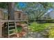 Backyard treehouse with slide, swings, ladder, and trampoline is perfect for outdoor fun and recreation at 2403 W Sunset Dr, Tampa, FL 33629