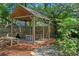 A wooden playhouse features play tables and other equipment for imaginative play at 2403 W Sunset Dr, Tampa, FL 33629