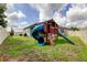 Expansive backyard boasts large play structure with slide, set on lush grass, perfect for outdoor enjoyment at 2456 Arbor Wind Dr, Lutz, FL 33558