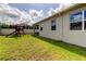 Beautiful backyard featuring well-maintained lawn, playhouse, and exterior view of home with windows at 2456 Arbor Wind Dr, Lutz, FL 33558