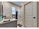 Bright bathroom featuring a vanity with sink, glass-enclosed shower, and modern fixtures at 2456 Arbor Wind Dr, Lutz, FL 33558