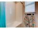 Bright bathroom showcasing a tiled shower and tub combination with colorful towels at 2456 Arbor Wind Dr, Lutz, FL 33558