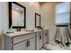 Double vanity in a modern bathroom, featuring mirrors and neutral tile floors at 2456 Arbor Wind Dr, Lutz, FL 33558