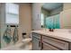 Bathroom with vanity, toilet, and towels hanging near the window at 2456 Arbor Wind Dr, Lutz, FL 33558