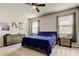 Cozy bedroom featuring neutral tones, soft carpeting, and ample natural light through the windows at 2456 Arbor Wind Dr, Lutz, FL 33558