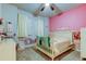 Bright bedroom with a pastel color scheme featuring a comfortable bed and decorative accents at 2456 Arbor Wind Dr, Lutz, FL 33558