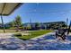 Charming outdoor common area with Adirondack chairs, string lights, and landscaping for residents to enjoy at 2456 Arbor Wind Dr, Lutz, FL 33558