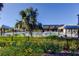 Community pool view showcasing the relaxing outdoor space with lounge chairs, a cabana, and lush greenery at 2456 Arbor Wind Dr, Lutz, FL 33558