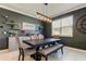 Dining area featuring a wooden table, bench, chairs, and a decorative wall with floating shelves at 2456 Arbor Wind Dr, Lutz, FL 33558