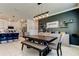 Open dining room featuring stylish light fixture, elegant decor, and modern kitchen view at 2456 Arbor Wind Dr, Lutz, FL 33558