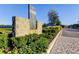 Elegant stone entrance sign for Parkview at Long Lake Ranch, set amidst manicured landscaping and a paved walkway at 2456 Arbor Wind Dr, Lutz, FL 33558