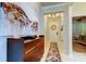Inviting entryway featuring neutral paint, tiled floor, modern console table, and decorative wreath at 2456 Arbor Wind Dr, Lutz, FL 33558