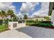 Community grilling area complete with built-in grill, lush landscaping, and a view of nearby homes at 2456 Arbor Wind Dr, Lutz, FL 33558