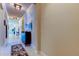 Bright hallway with light tile flooring, modern light fixtures, and neutral wall colors at 2456 Arbor Wind Dr, Lutz, FL 33558